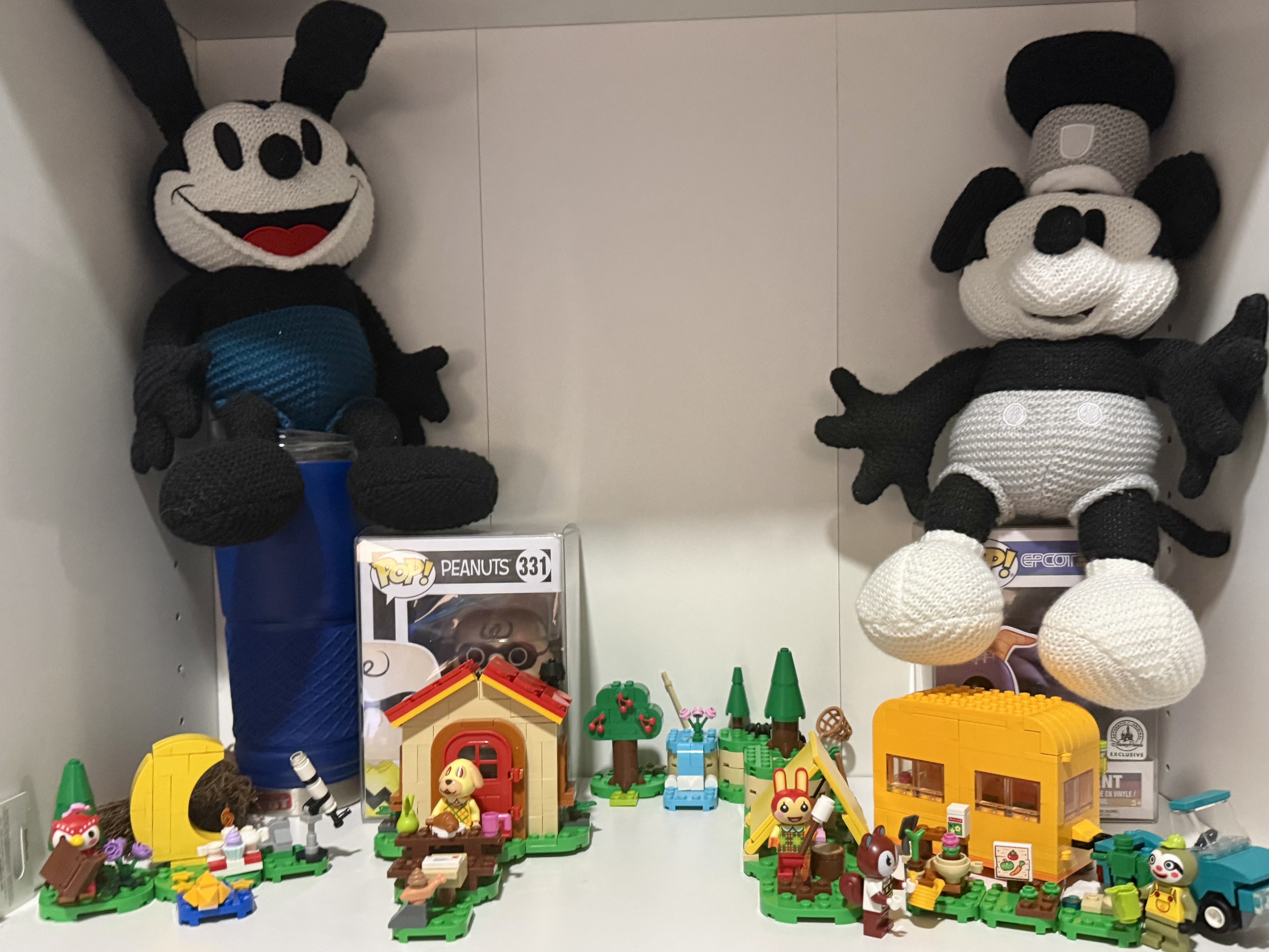 Streaming setup shelf with crocheted Oswald plushies, Cirkul water bottle, and LEGO Animal Crossing sets