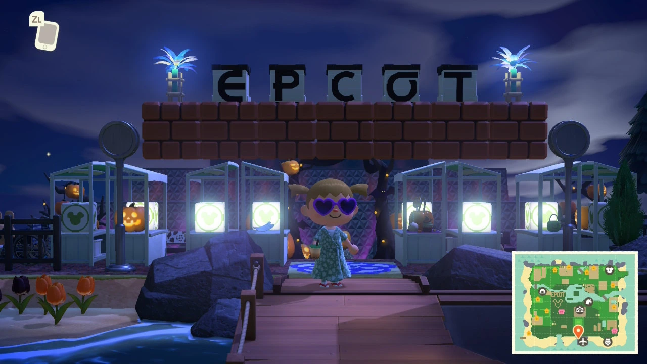 Disney-themed EPCOT entrance area at night with illuminated signage, character in purple sunglasses, and festival decorations