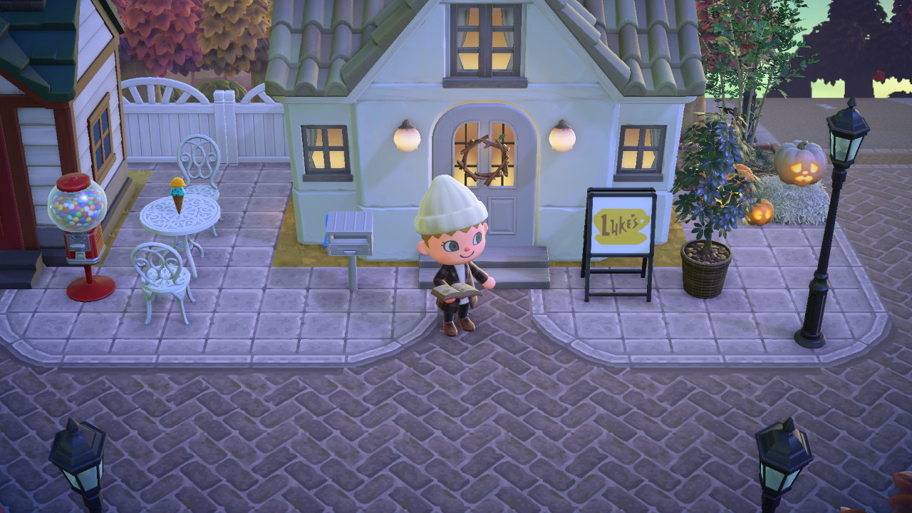 Animal Crossing character outside cute house with Luke's sign